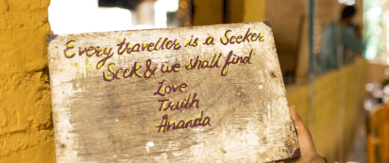 A hand-painted sign at the ashram: every traveller is a seeker